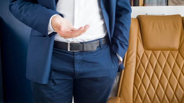 Closeup image of businessman standing at office and tossing coin — Stock Photo, Image