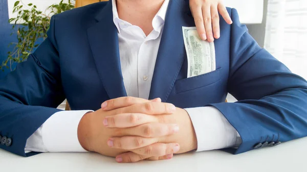 Closeup image of wife taking money from her husbands jacket pocket — Stock Photo, Image