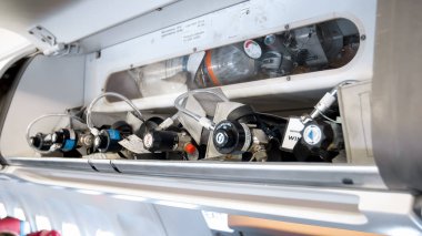 Closeup image of emergency safety system wuth valves and tubes on modern jet airplane clipart