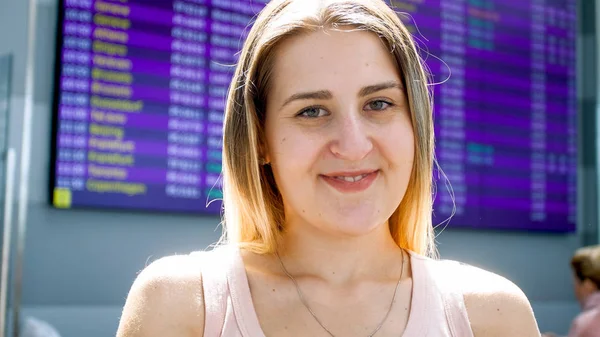 Portret uśmiechający się młoda kobieta, fro czeka lot w terminalu międzynarodowego lotniska — Zdjęcie stockowe