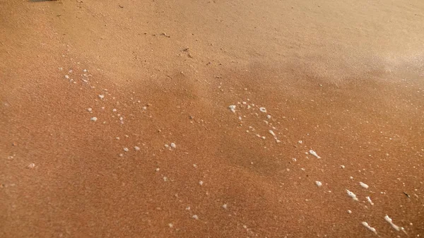 Closeup image of wet sand on the ocean beach at sunset — Stock Photo, Image