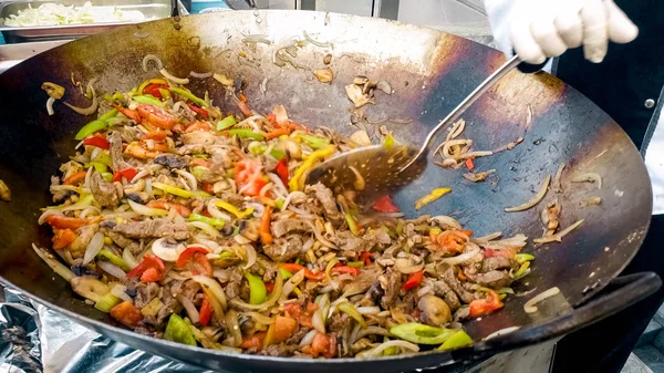 Closeup photo of cooking vegetables and meat outdoors in the frying pan — Stock Photo, Image