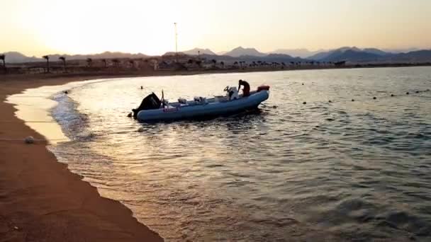 4k-beelden van motorboot op kalme SESA-golven bij zonsondergang licht — Stockvideo