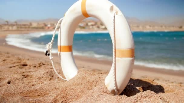 4k slow motion video of life saving ring on the ocean beach at stormy day — Stock Footage 4k slow motion video of life saving ring on the ocean beach at stormy day Royalty Free Stock Footage