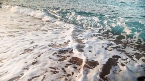 Extreme slow motion video of rolling ocean waves in sun rays. Amazing landscape of the sea — Stock Video