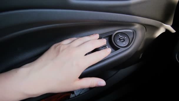 Closeup slow motion video of female hand pressing windows control knobs on dashboard — Stock Video