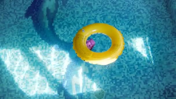 Filmagem 4k do anel inflável para crianças na superfície da água da piscina — Vídeo de Stock