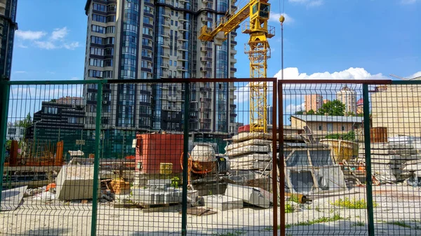 Image of modern building construction behind the wired fence at bright sunny day — Stock Photo, Image