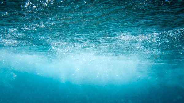 Beautiful image from under the water on rolling and swirling sae wave tube — Stock Photo, Image