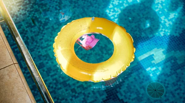 Closeup image of inflatable yellow children ring for swimming in the swimming pool — Stock Photo, Image
