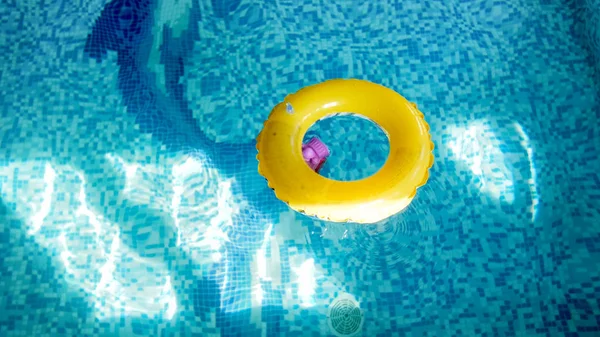 Closeup image of inflatable yellow children ring for swimming in the swimming pool — Stock Photo, Image