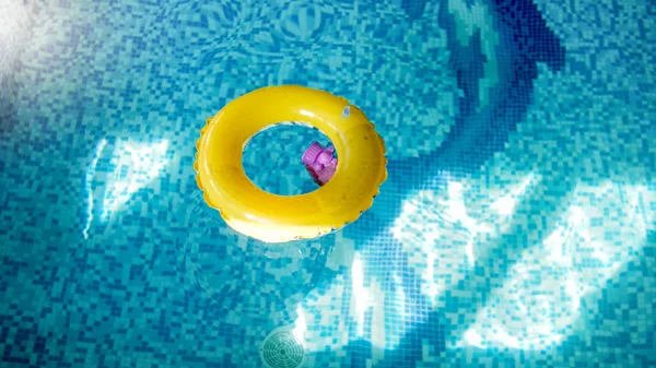 Closeup image of inflatable yellow ring for children in swimming pool — Stock Photo, Image