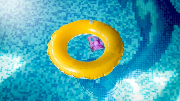 Closeup image of inflatable yellow children ring for swimming in the swimming pool — Stock Photo, Image