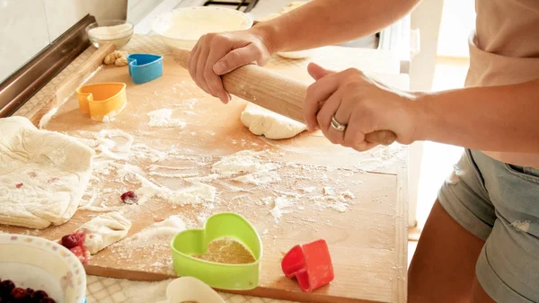 Closeup photo of young woman making dough for pizza. Housewife rolling dough with wooden rolling pin — Stock Photo, Image