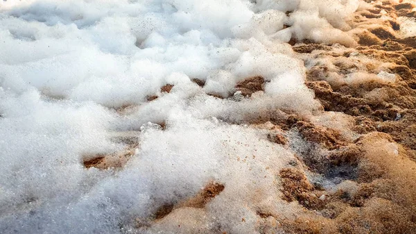Primo piano immagine astratta di un sacco di schiuma di sapone dopo mare spiaggia discoteca partito sdraiato sulla riva sabbiosa — Foto Stock