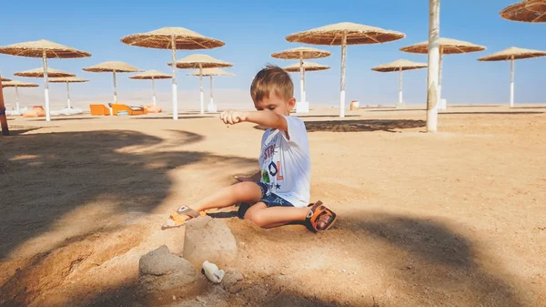 Portret Cute Little Boy podejmowania piasku zamek na plaży Morza — Zdjęcie stockowe