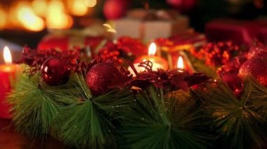 Noel arifesinde yanan mumlarla gelen güzel çelengin 4k doli videosu. Noel veya Yeni Yıl için mükemmel bir arkaplan veya arkaplan
