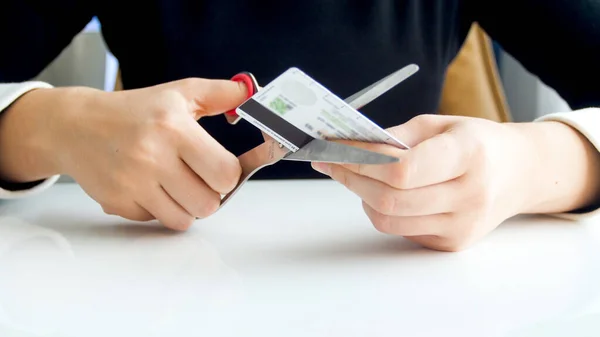 Zbliżenie obrazu kobiety pracownika banku cięcia plastikowej karty kredytowej — Zdjęcie stockowe