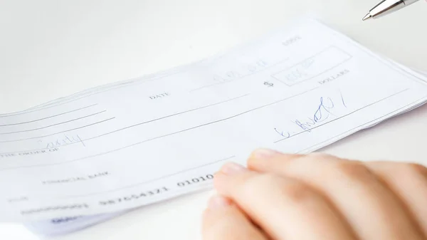 Closeup image of filled and signed banking cheque — Stock Photo, Image