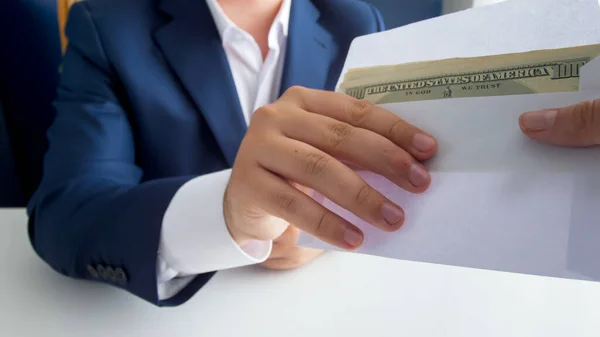 Closeup image of corrupted male politician taking money bribe in envelope. Concept of corruption in politics and government — Stock Photo, Image