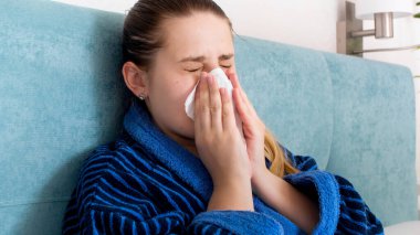 Hasta bir kadının portresi soğuk burnu kağıt mendille akıyor.