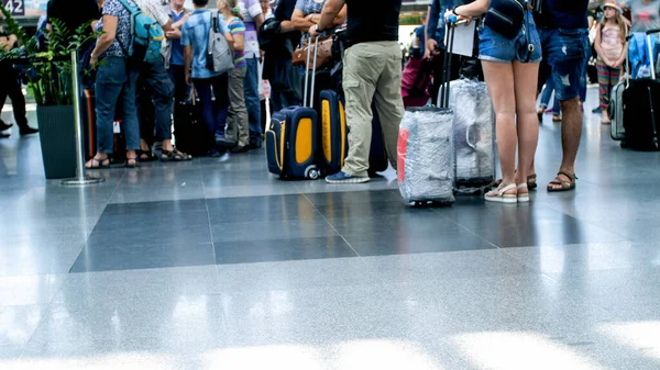 Image floue de la foule de personnes avec des bagages en file d'attente dans le terminal de l'aéroport — Photo