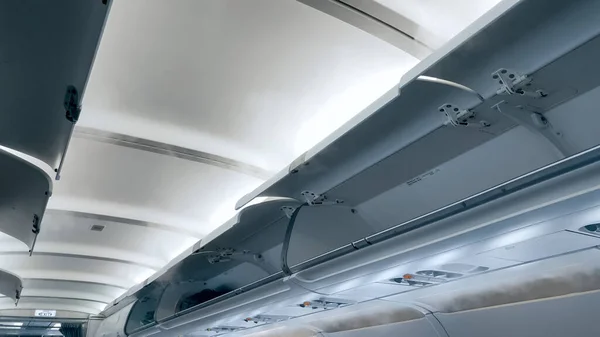 Moder airplane ceiling and open luggage compartment — Stock Photo, Image
