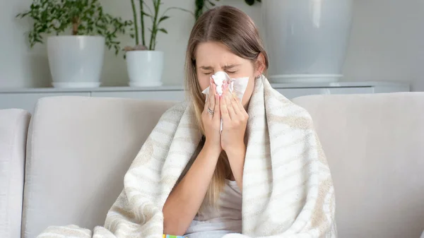 Portrait of sick woman with runny nose blowing nose in paper tissue — Stok Foto