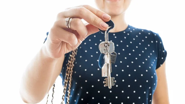 Closeup photo of young woman holding keys from new house and showing it in camera — Stock Photo, Image