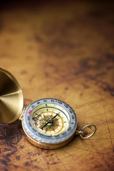 Vintage compass and old navigation map.