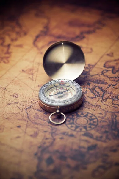 Vintage compass and old navigation map.