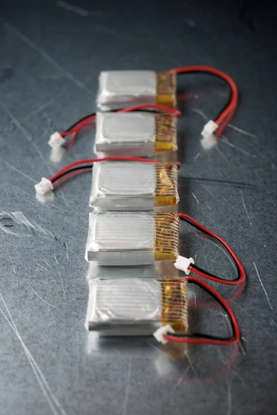 Drone batteries on a metal table.