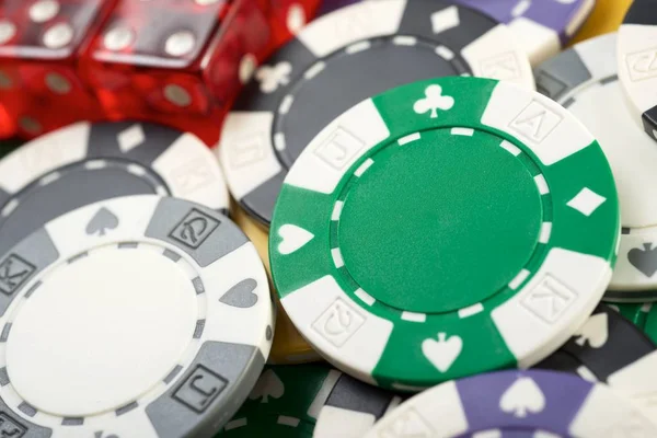 casino chips and dices on a green felt