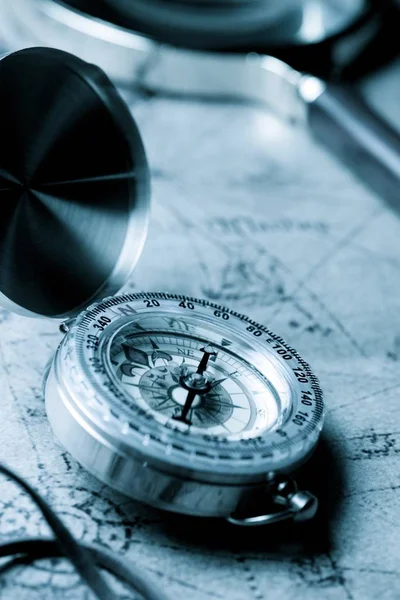 Vintage compass and old navigation map.