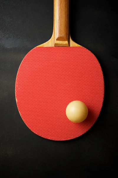 Ball and racquet to play ping pong.