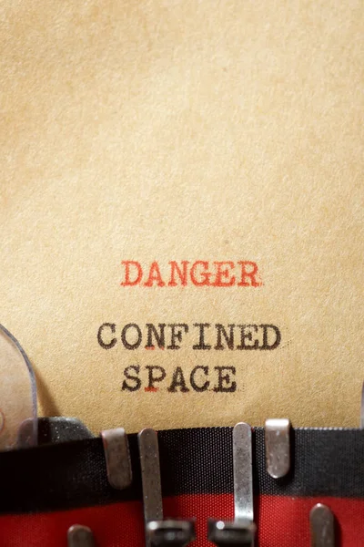 Danger confined space phrase written with a typewriter.