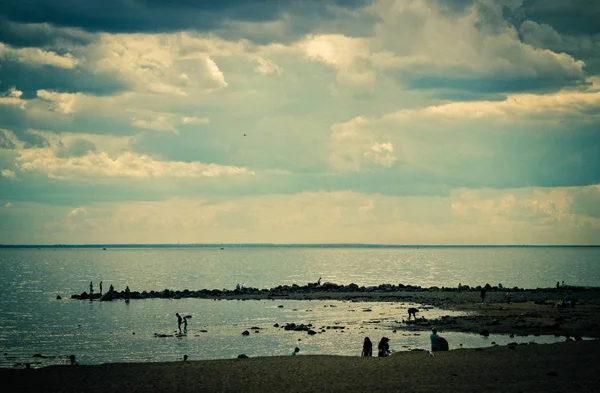 seascape, the beach where people walk, clouds over the sea, Bay beach, people rest