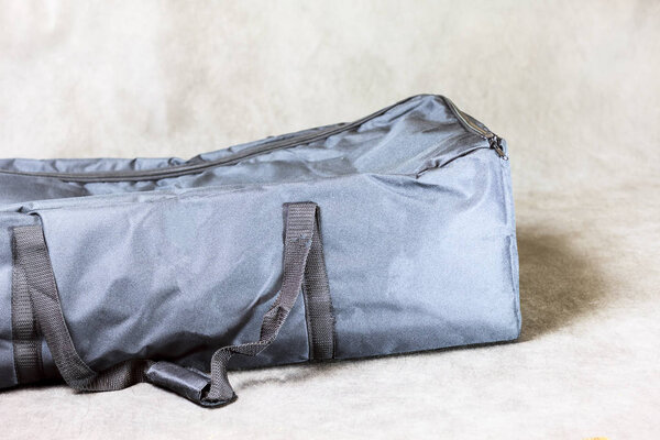 large closed dark bag on a dark background.