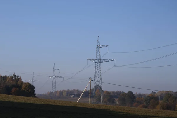 high voltage power lines. horizon line is wrong. electrical distribution station.