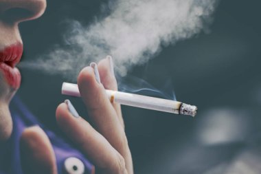 kız sadece bir sigara onun elinde tutan duman onun dudakları exhales yaptı. kesim sığ derinliği. Orada tonlama.