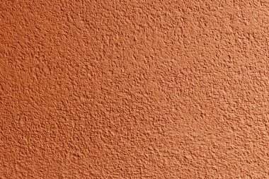 Duvar. alçı uygulanır. küçük taşların bileşimi. ve özel bir şekilde dövülen. çerçeve konumu. şeftali rengi