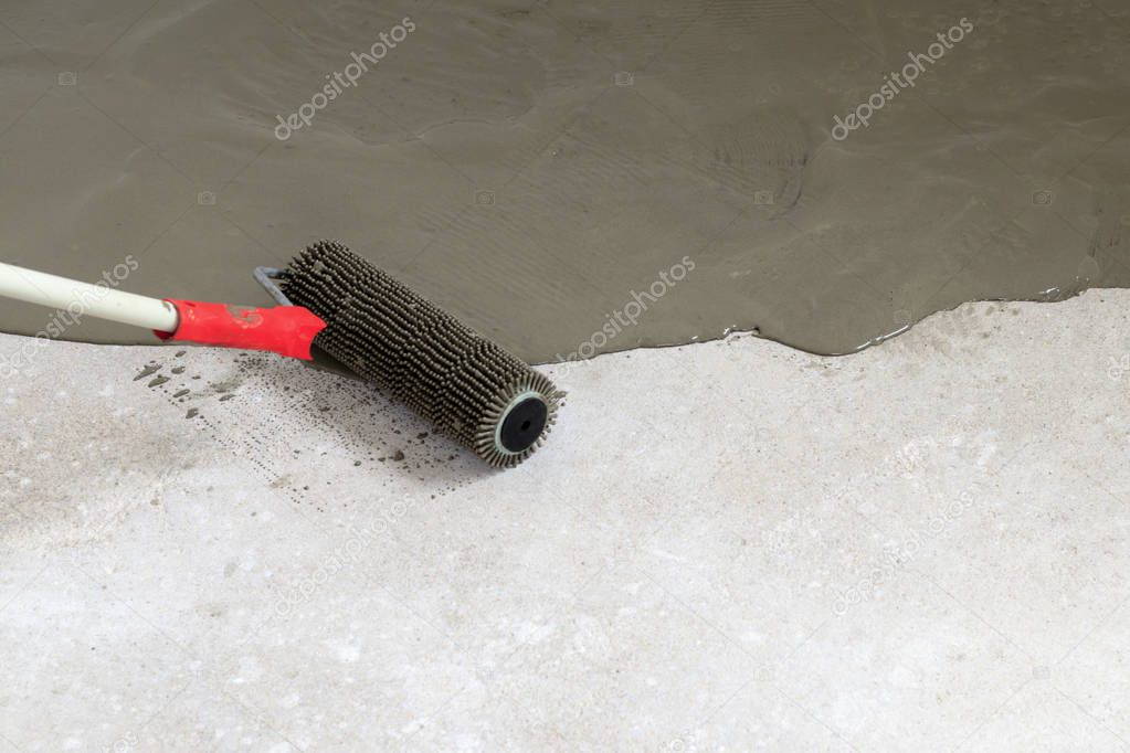 concrete floor. on the horizon. close-up. needle roller for removing air bubbles. have toning. then there will be painting.