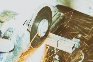 zımparalama makinesi. birçok sparks yakmak ve iş. kare boru keser. Tonlama var. yakın çekim