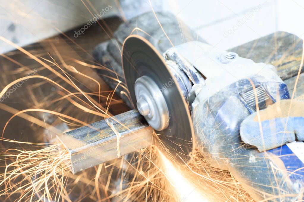 sanding machine. many sparks burn and work. cuts a square pipe. have toning. close-up