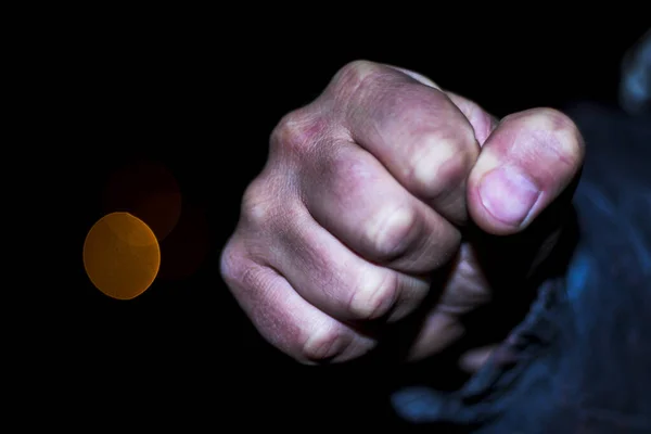 Fist. night. The concept of street violence in the house. after him the flashlight is out of focus. — Stock Photo, Image