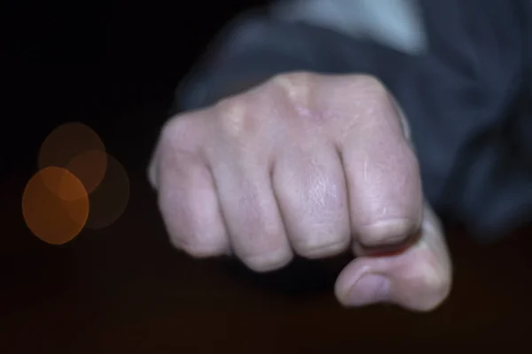 No focus. male fist. night. concept of street violence at home. — Stock Photo, Image