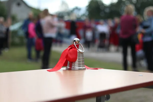 street lighting. metal bell on the school desk. The background is blurred in the background