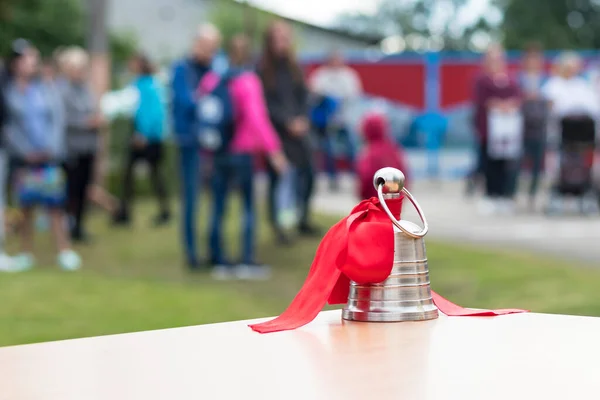 street lighting. metal bell on the school desk. The background is blurred in the background