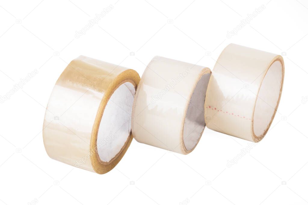 Transparent adhesive tape on a white background. One lighter second yellow. Close-up. isolate