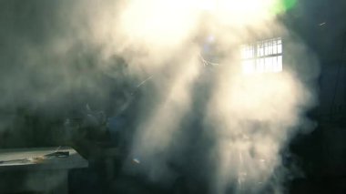 Beyaz önlük giyen isimsiz bir adam okul laboratuarında kimyasalları karıştırıyor..